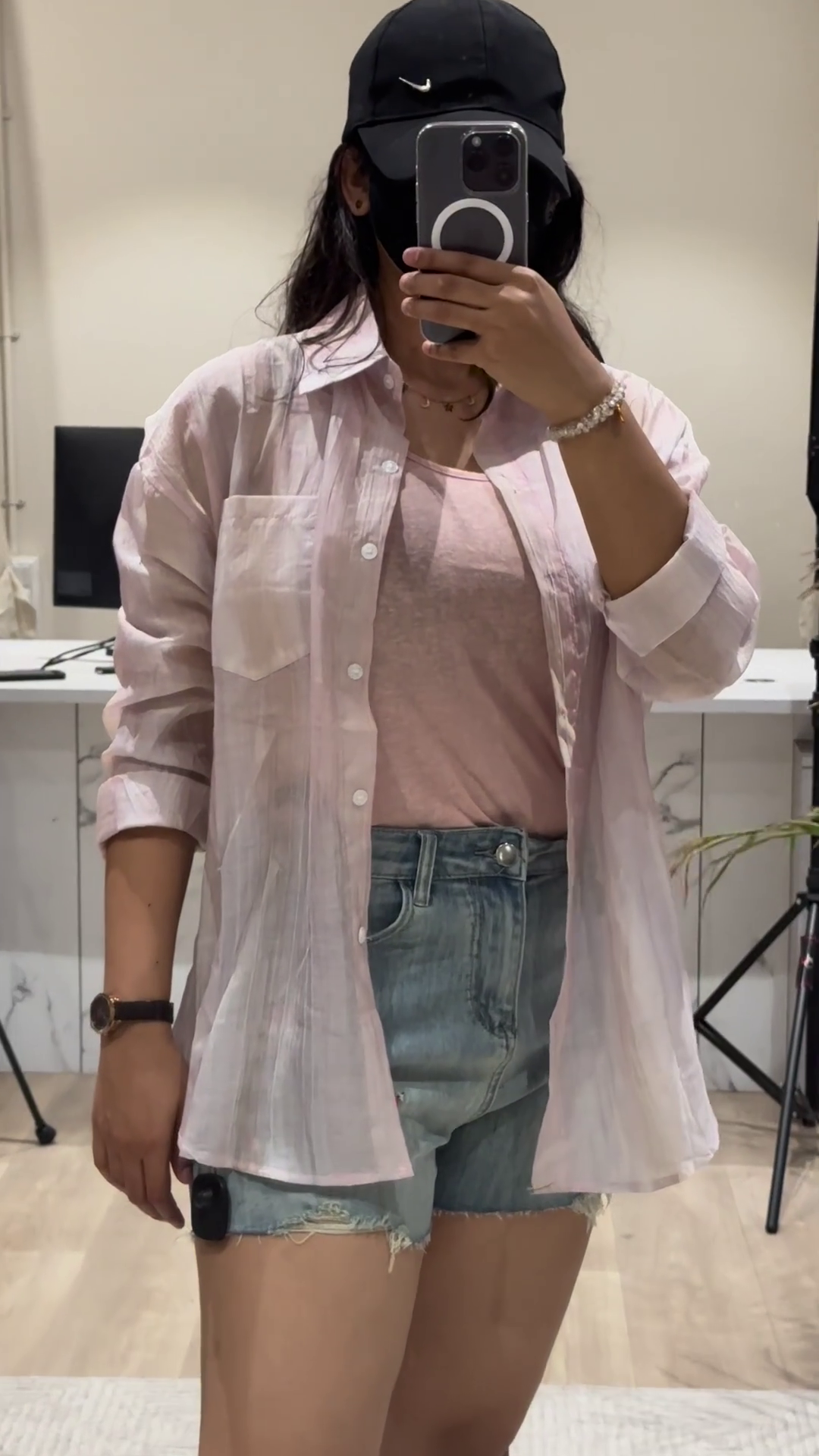 Casual Layered Outfit: Pink Button-Down Shirt, Tank Top, and Denim Shorts