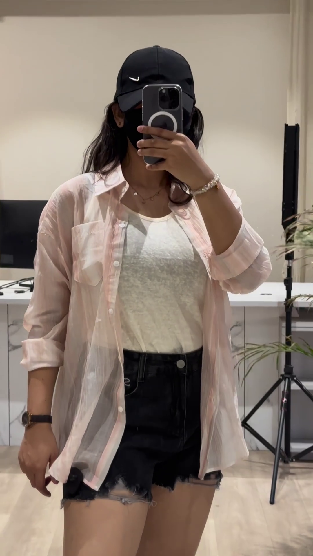 Casual Layered Outfit: Pink Button-Down Shirt, Tank Top, and Denim Shorts - Image 3